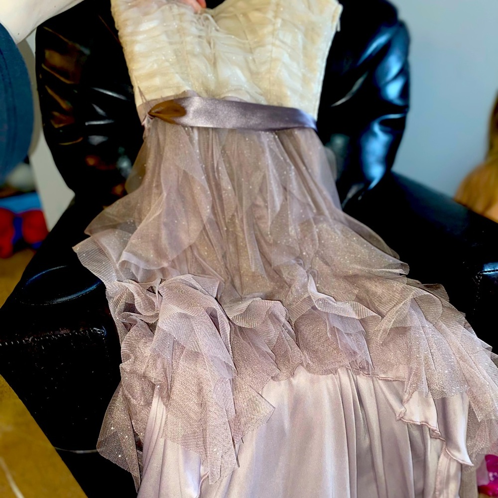 Open in the front- long in the back! Perfect to twirl in.